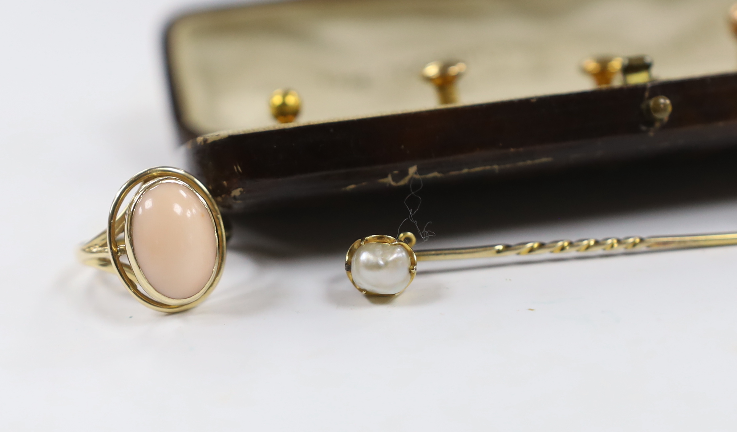 Sundry jewellery including a 14ct gold and cabochon coral set ring, a 9ct gold and gem set ring, a yellow metal and gem set bar brooch, a yellow metal and baroque pearl set stick pin and a cased five piece dress stud set